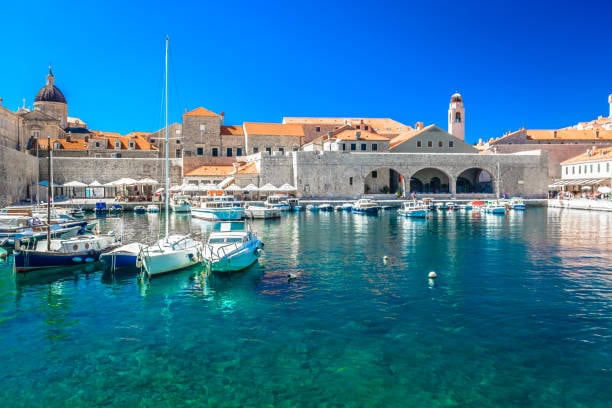 Dubrovnik's old harbour with small boats, seen from the water
