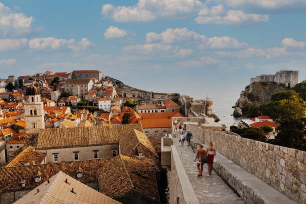Walking on Dubrovnik's city walls above the rooftops