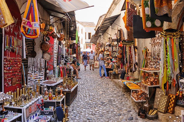 Souvenir stalls along a cobbled street in Mostar's old bazaar