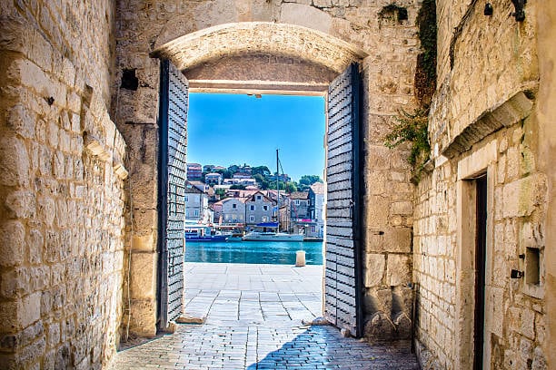 Stone gateway in Trogir opening onto the sea