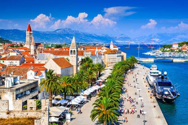 Trogir waterfront with palm trees and the old town bell towers